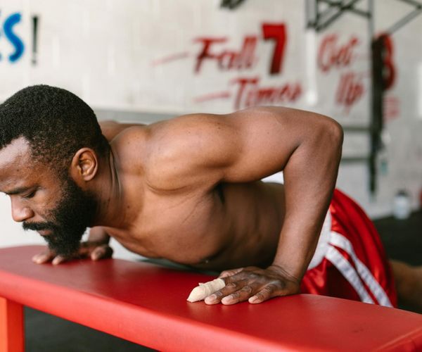 Man focused during a challenging bodyweight exercise.